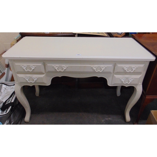 32 - Cream painted dressing table, having five short drawers with metal handles and on cabriole supports,... 