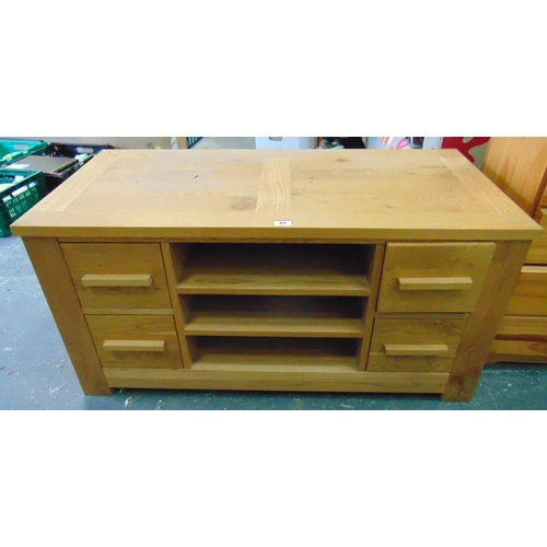 44 - Contemporary oak side table, having three drawers to either side, 22 x 45 x 22