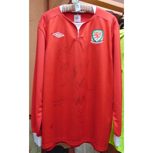 61 - A signed Welsh football shirt, including  the signature of Gary Speed.