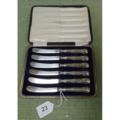 23 - Cased set of six silver handled butter knives.