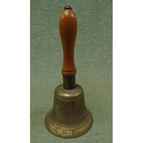 31 - An ARP brass hand bell, having turned wooden handle, impressed marks JB 39, 10