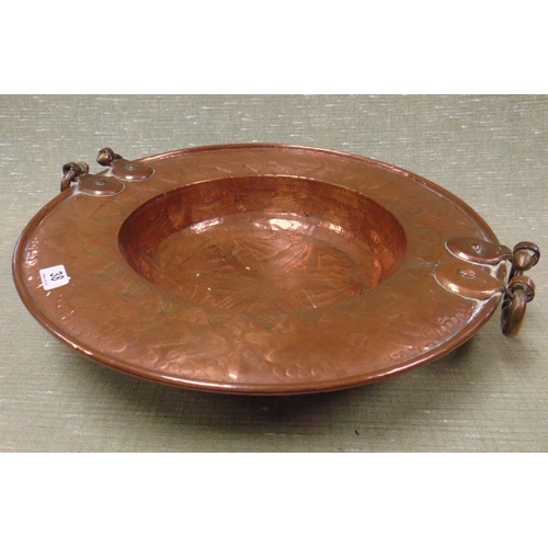 38 - Large Eastern circular copper bowl, having side handles and moulded decoration, 21