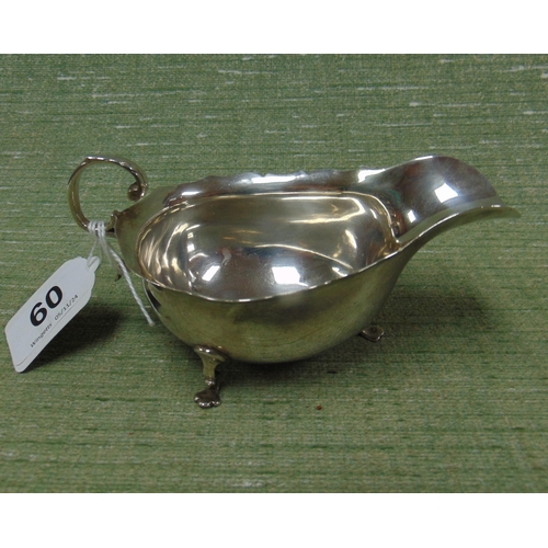 60 - Silver sauce boat, having scroll handle and on pad feet, maker Streeten & Co, Bond Street London, 19... 