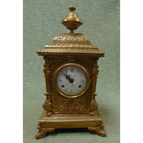 65 - Imperial ornate gilt metal mantle clock, having finial mount, enamel face and Roman numerals, 17 x 9... 