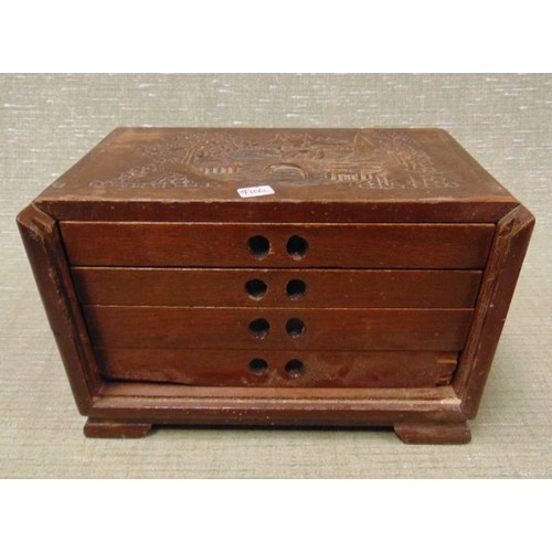 131 - An Oriental hardwood table top chest, having four drawers and carved decoration, 7 x 10 x 6.5