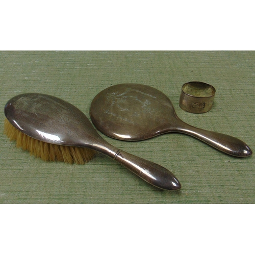 166 - Two Chester silver backed dressing table brushes and a silver napkin holder.