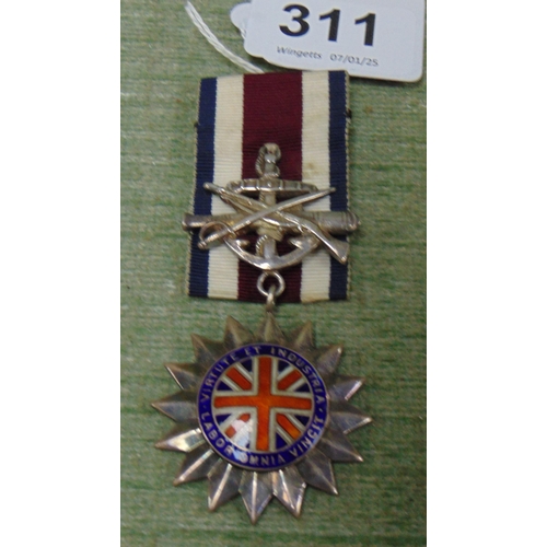 311 - Silver Smith & Wesson six point medal for exemplary service in the corps.