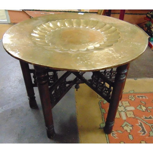 333 - Brass topped Eastern centre table, set on folding base, 22 x 29