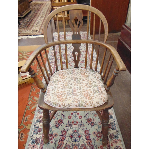 334 - An elm windsor chair, hooped top rail,  pierced back, solid seat, on turned supports and crinoline s... 