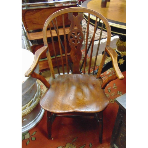 344 - Antique elm Windsor chair, wheel back, open arms, solid seat, on turned supports and stretchers.