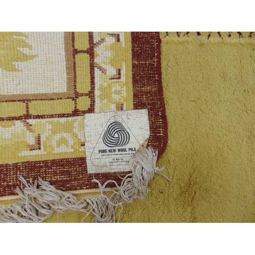 363 - Yellow and brown ground rug, having geometric pattern, 145 x 109