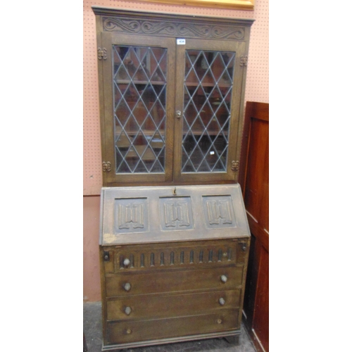 434 - An oak bureau bookcase, leaded glazed upper portion, fall front revealing a fitted interior, four lo... 