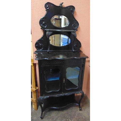 439 - 19th century ebony side cabinet, mirror back over pair of glazed doors enclosing a shelf lined inter... 