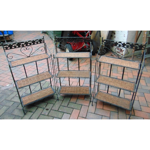 453 - Set of three metal framed folding rattan shelves.