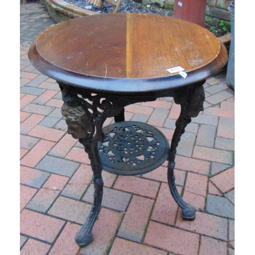 470 - Cast metal girl's head pub table, having circular wooden top.