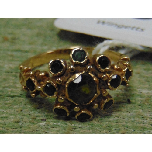 89 - 9ct gold ring, set with green coloured stones, size M, 2.6 gms.