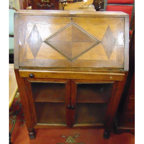 349 - An oak bureau, fall front revealing a fitted interior, pair of glazed doors and on shaped feet,  43 ... 