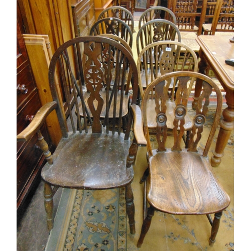 352 - Seven elm wheel back dining chairs, and one other example (7 + 1).