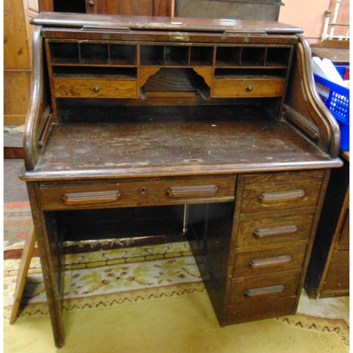 355 - An oak roll top desk.