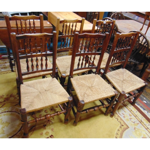 356 - Six elm spindle back rush seated chairs.