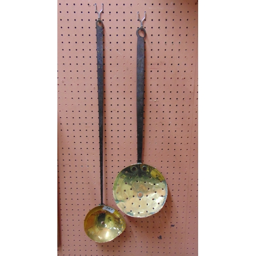 387 - Antique brass milk skimmer and one other example.