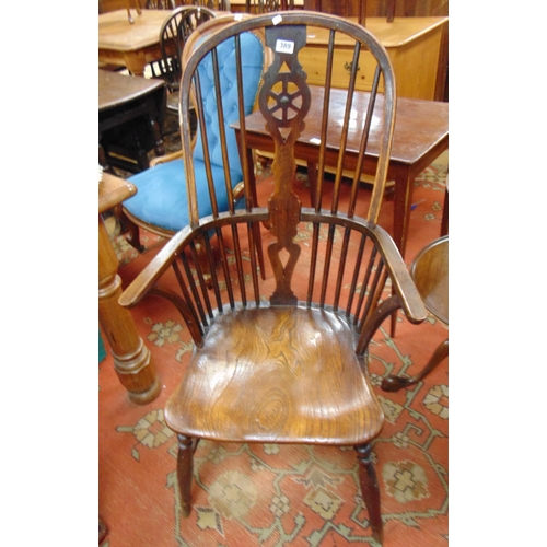 389 - 19th century elm Windsor chair, hoop back, wheel splat, open arms, solid seat, on turned supports an... 