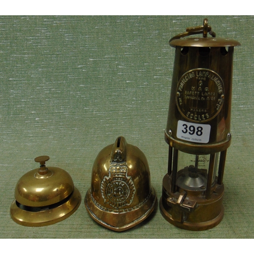 398 - Eccles safety miner's lamp, brass desk bell and a novelty policeman's helmet money box.