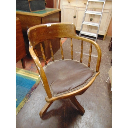 346 - Edwardian oak spindle back swivel office chair, having hide upholstered seat.