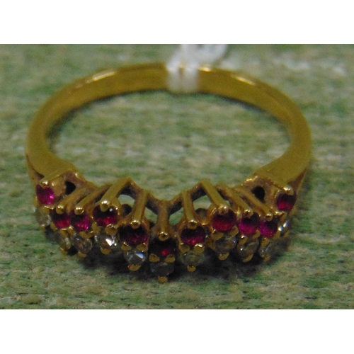 117 - Possibly gold ring, set with ruby and clear stones, size N.