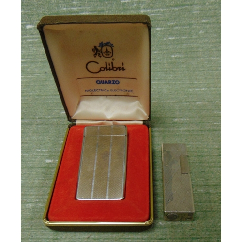 133 - Two Colibri cigarette lighters.