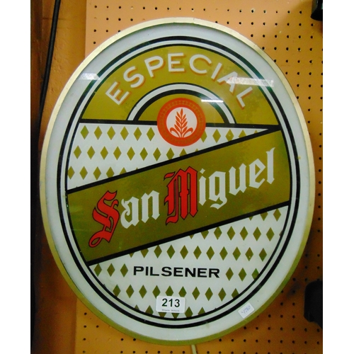 213 - An illuminated San Miguel advertising sign.