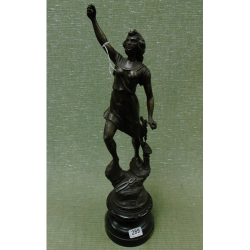 289 - Painted French metal figure, modelled as a lady stood on a plinth. 24