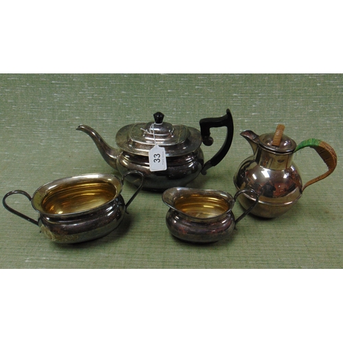 33 - Plated three piece tea service and a plated Guernsey jug.