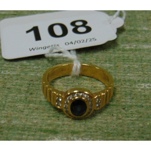 108 - 750 gold marked ladys' ring, set with central sapphire surrounded by diamond chips, size N. 5.8 gms ... 