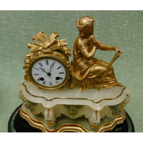 50 - Ornate gilt clock, having figural decoration, contained under a glass dome.