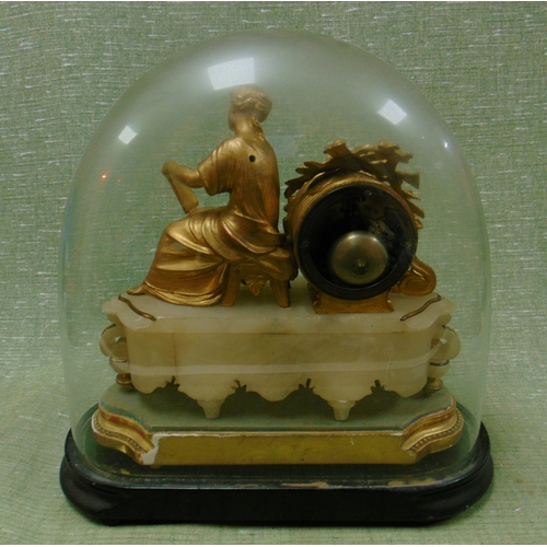 50 - Ornate gilt clock, having figural decoration, contained under a glass dome.