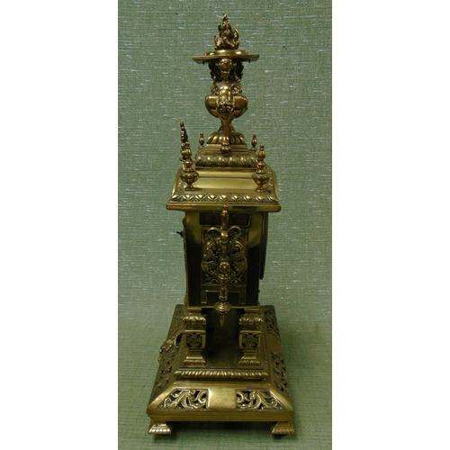 17 - Ornate antique brass mantle clock, having cherub form finial mounts, enamel Roman numerals, all over... 