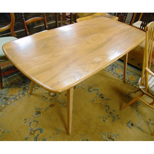 An Ercol dining suite, comprising rectangular table and six stick back ...