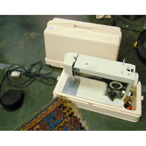 101 - Cased Toyota electric sewing machine.