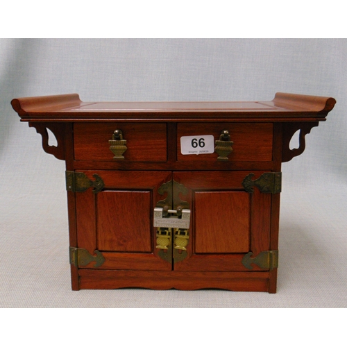 66 - Reproduction Oriental table top chest, having shaped ends, pair of short drawers and two panel doors... 