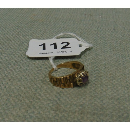 112 - 9ct gold ring, set with purple stone, size R, 4.7 gms.