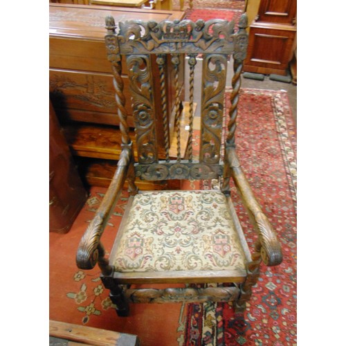 228 - An oak carver chair, having open arms, upholstered seat and carverd decoration.