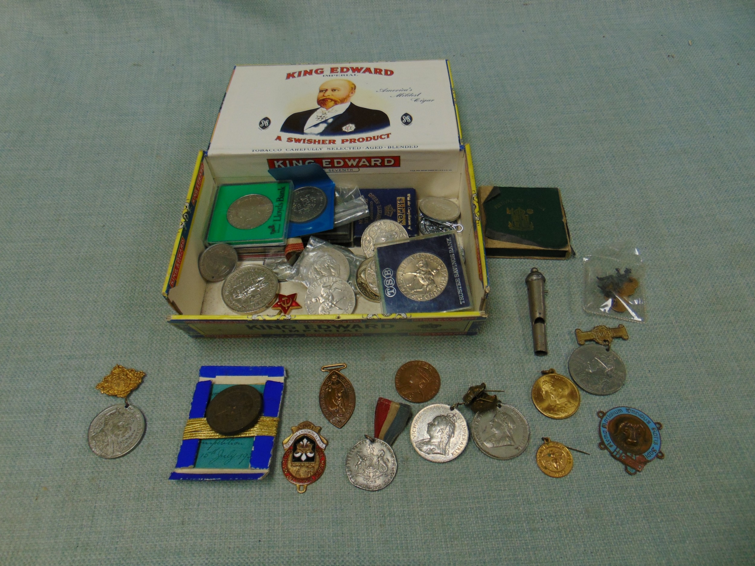 Box of coins, whistle, medals.