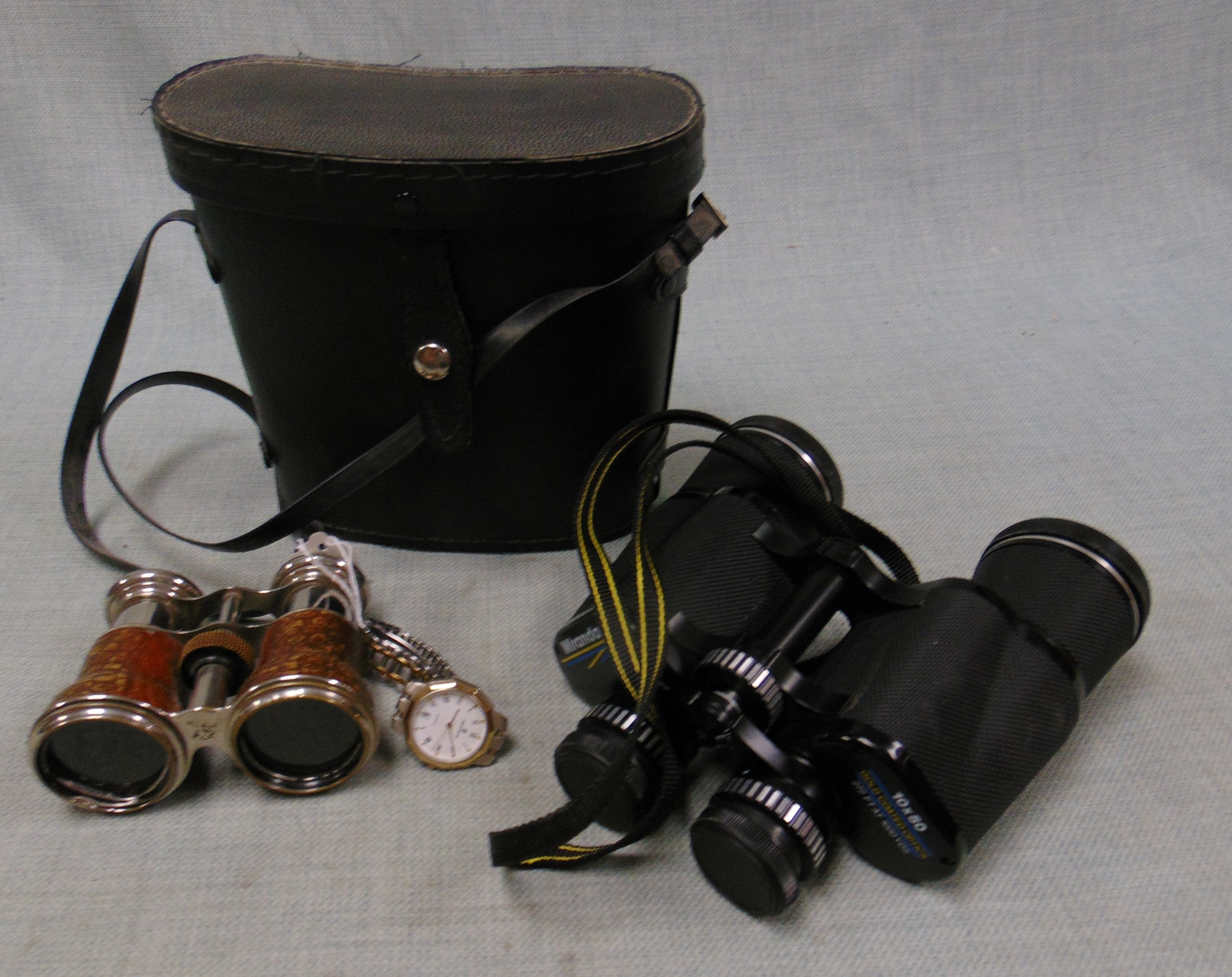 Cased pair of binoculars, opera glasses, and a Pierre Cardin watch.