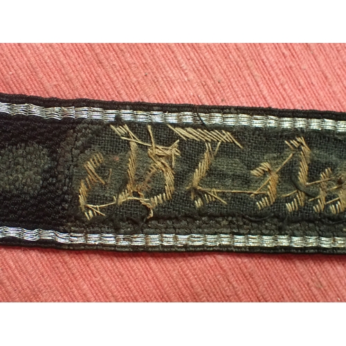 190 - WW2 German SS Schule-Tolz cuff title

FINELY WOVEN ALUMINIUM WIRE WORK SCRIPT. FOLDED AND STITCHED E... 