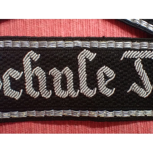 190 - WW2 German SS Schule-Tolz cuff title

FINELY WOVEN ALUMINIUM WIRE WORK SCRIPT. FOLDED AND STITCHED E... 