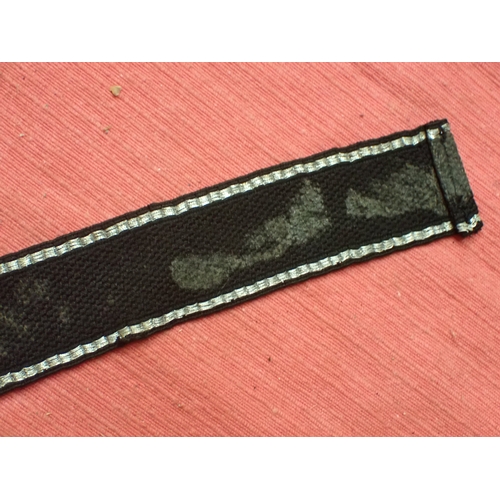 190 - WW2 German SS Schule-Tolz cuff title

FINELY WOVEN ALUMINIUM WIRE WORK SCRIPT. FOLDED AND STITCHED E... 