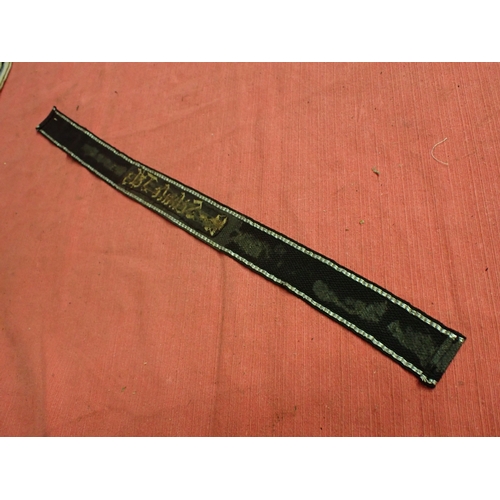 190 - WW2 German SS Schule-Tolz cuff title

FINELY WOVEN ALUMINIUM WIRE WORK SCRIPT. FOLDED AND STITCHED E... 
