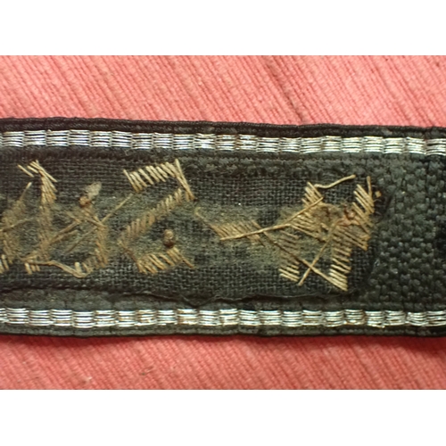 190 - WW2 German SS Schule-Tolz cuff title

FINELY WOVEN ALUMINIUM WIRE WORK SCRIPT. FOLDED AND STITCHED E... 
