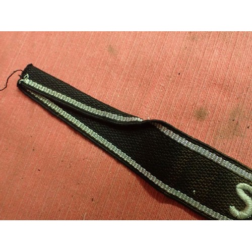 13 - WW2 SS-Feldgendarmerie cuff title

Aluminium wirework edging. The script is in a grey-silver-coloure... 